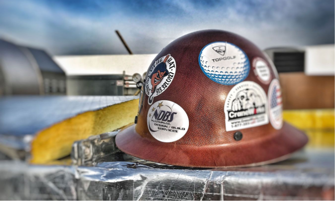 Closeup of hard hat with NDBS stickers